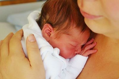 Close-up of woman touching baby