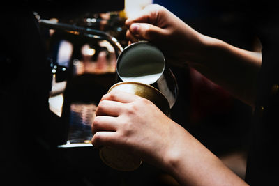 Close-up of hand holding coffee cup