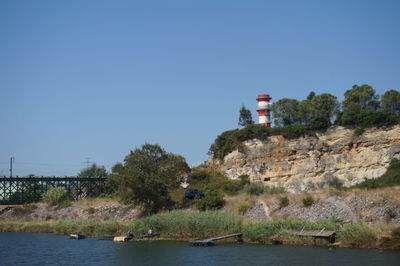 Calm lake against clear blue sky