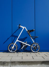 Low angle view of bicycle against blue sky