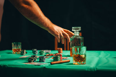 Midsection of man playing glasses on table