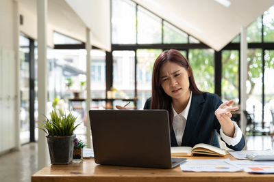 Businesswoman using laptop at office