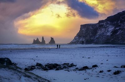 Scenic view of beach against sky during sunset