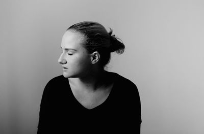 Close-up of young woman against gray background