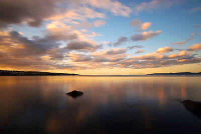 Scenic view of lake against sky during sunset