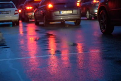 Wet car on road during rainy season at night