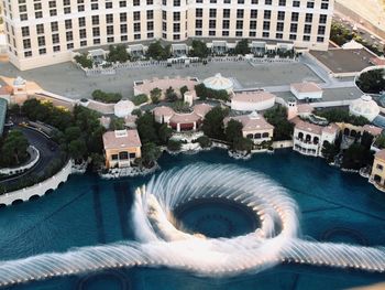 High angle view of swimming pool by buildings in city