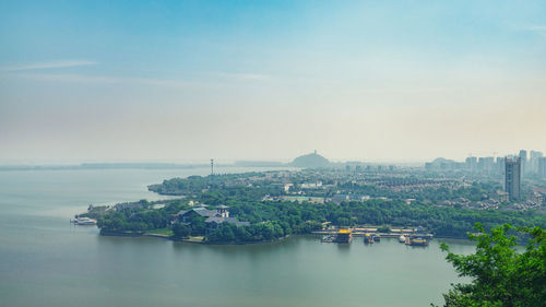 Scenic view of sea and buildings against sky