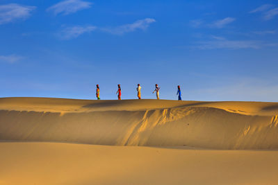 Sand dune in desert against sky