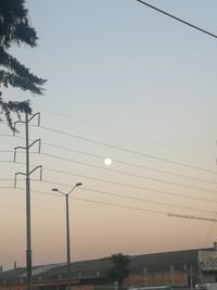 Low angle view of electricity pylon against sky