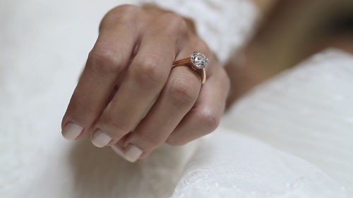 Close-up of hands holding wedding rings