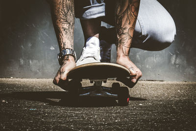 Tatooed person on a skateboard