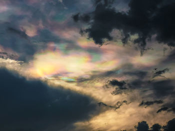 Low angle view of rainbow in sky at sunset