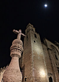 Low angle view of old building against sky at night