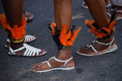 Passers-by dressed in costume are seen during the fuzue pre-carnival performance 