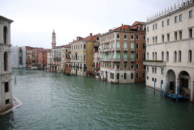 Canal passing through buildings in city