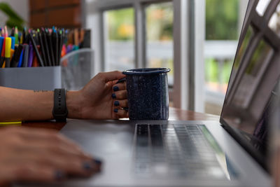 Man working with coffee cup on table