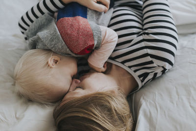 High angle view of baby sleeping on bed