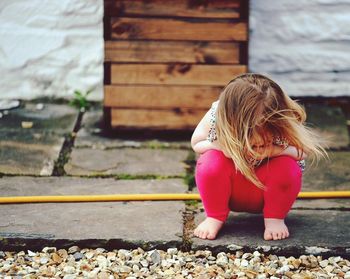 Girl looking at pebbles