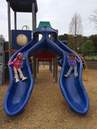 Playground in park against blue sky