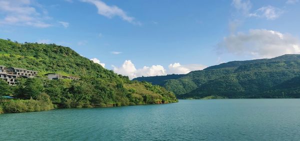 Scenic view of sea and mountains against sky