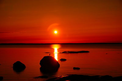 Scenic view of sea against romantic sky at sunset