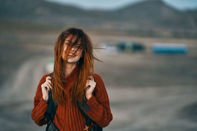 Portrait of smiling young woman standing outdoors