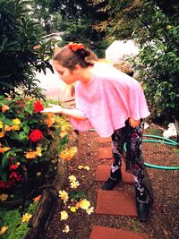 Girl standing by flowering plants