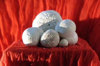 Close-up of stones on red table