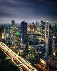 High angle view of city lit up at night