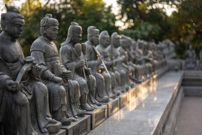 Sculpture of buddha statue in row