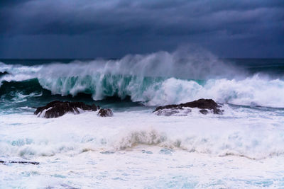 Scenic view of sea against cloudy sky