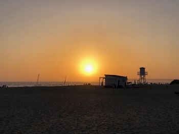 Scenic view of beach against sky during sunset