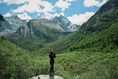 Woman standing against mountains