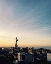 Cityscape against sky at sunset