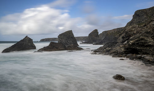 Rocks in sea against sky