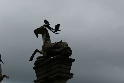 Low angle view of statue against sky