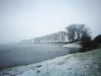 Scenic view of frozen lake against clear sky