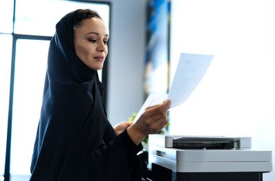 Portrait of young woman working in office