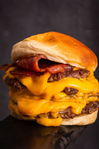 Close-up of burger against black background