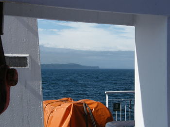 Rear view of woman looking at sea against sky