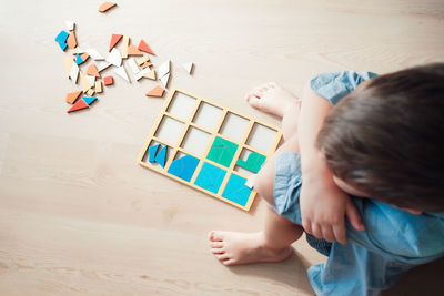 High angle view of boy playing with toy on floor