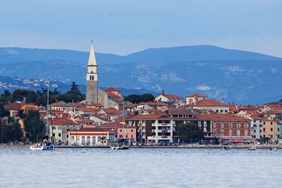 Traditional church by sea against sky