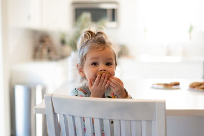 Portrait of cute boy eating food at home