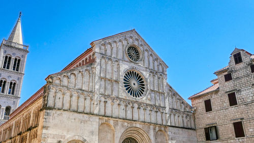 Low angle view of st. anastasia cathedral in zadar against clear blue sky