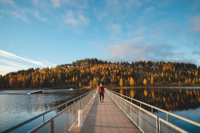 Autumn sunset at lake syvajarvi, in hyrynsalmi, finland. a young man in a plaid red and black shirt