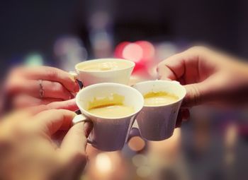 Close-up of hand holding coffee cup