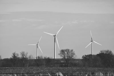 Windmill on field against sky