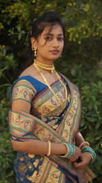 Portrait of a beautiful young woman standing outdoors