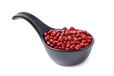 High angle view of strawberries in bowl against white background